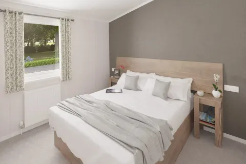 King-size master bedroom with walk-in dressing area in the 2025 Swift Montreal Lodge