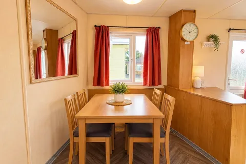 Dining area with table and chairs in the Cosalt Torbay static caravan at Coastfields Holiday Village in Ingoldmells