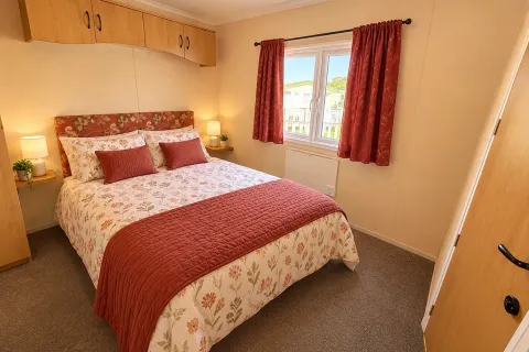 Double bedroom with fitted overhead storage in the 2002 Cosalt Torbay holiday home