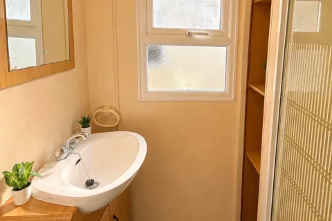 Shower room with enclosed shower and washbasin in the 2002 Cosalt Torbay static caravan