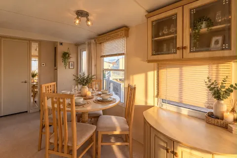 Dining area with wooden table and chairs beside the kitchen in the 2004 Atlas Heritage