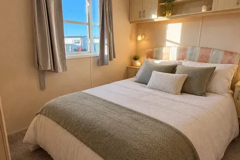 Main bedroom with double bed and fitted storage in the 2004 Atlas Heritage at Coastfields Holiday Village