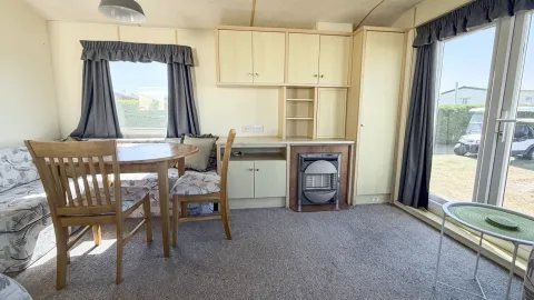 Spacious lounge inside the 2007 Atlas Lakeland Super holiday home with comfortable family seating.