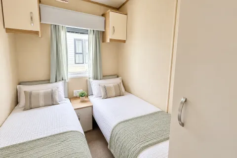 2016 ABI Sunset Coastfields twin bedroom with two single beds and overhead storage