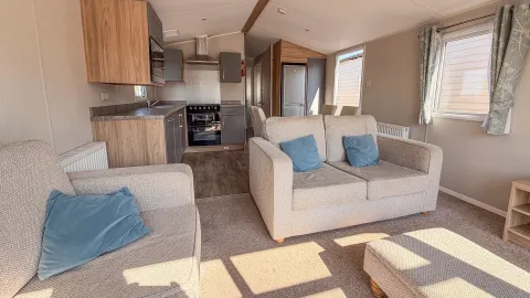 Living room of the 2021 willerby malton with comfortable seating and large windows