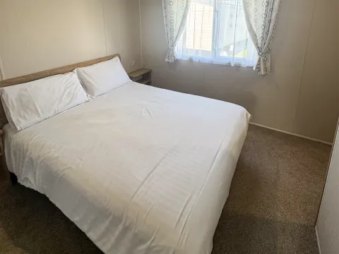 Spacious master bedroom with built-in storage in the 2022 Willerby Malton.