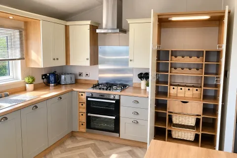 Contemporary kitchen with integrated appliances and fitted units in the Willerby Portland Lodge