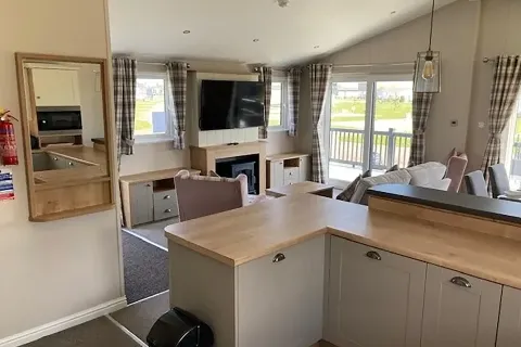 Open-plan lounge and dining area with upholstered seating in the 2023 Willerby Portland Lodge