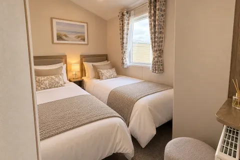 Comfortable twin bedroom with two single beds and fitted storage in the 2026 Willerby Malton three-bedroom caravan