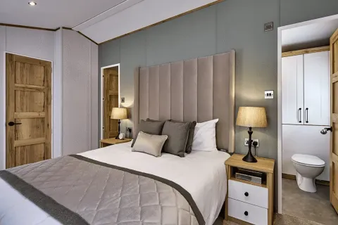 Luxurious main bedroom with upholstered headboard and elegant furnishings in the Willerby Dorchester