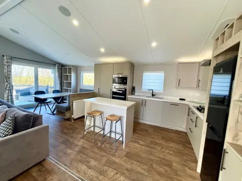 Modern kitchen with central island in the 2021 Willerby Mapleton lodge