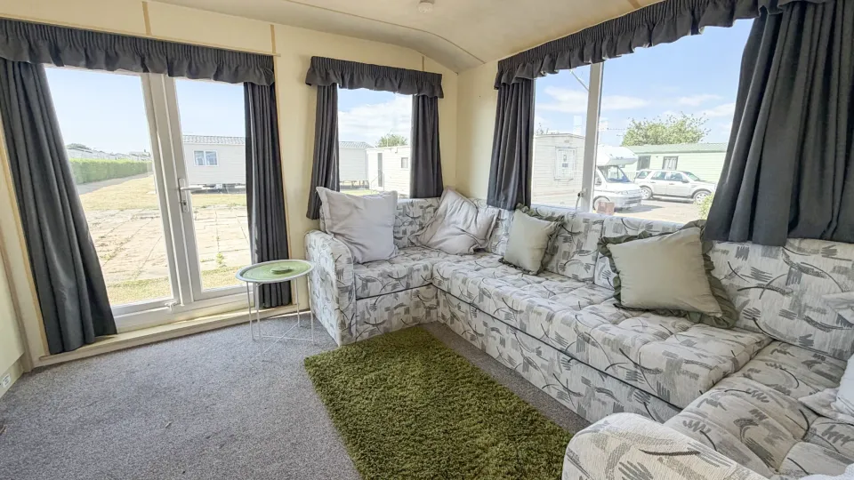 Spacious lounge inside the 2007 Atlas Lakeland Super holiday home with comfortable family seating.